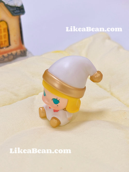 Small figurine with a white hat and yellow headband on a light surface, with 'LikeaBean.com' branding.