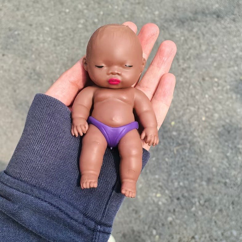 Art Toy Familia Natasha Squeeze Toy — held in palm showing size, purple underwear