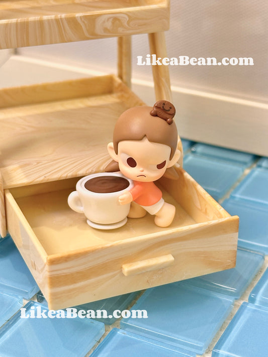 Small figurine of a child with a cup on a wooden shelf, with 'LikeaBean.com' branding.